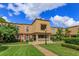 Inviting townhome showcases manicured lawn, lush landscaping, and charming architectural details at 200 Saint Andrews Blvd # 2607, Winter Park, FL 32792