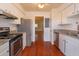 Updated kitchen features white cabinets, granite counters, and stainless steel appliances at 200 Saint Andrews Blvd # 2607, Winter Park, FL 32792