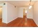 This living room has wood floors and doorways to other rooms in the home at 200 Saint Andrews Blvd # 2607, Winter Park, FL 32792