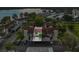 Aerial view of condo community with lake in the background. Includes parking and mature landscaping at 240 Killarney Bay Ct # 4, Winter Park, FL 32789