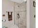 Updated shower with glass door, tiled walls and floor, and modern fixtures at 240 Killarney Bay Ct # 4, Winter Park, FL 32789