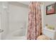 Bright bathroom featuring a tub, tiled walls, neutral finishes, and decorative accents at 240 Killarney Bay Ct # 4, Winter Park, FL 32789