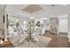 Elegant dining room with a glass table, seating for six, and a stylish chandelier at 240 Killarney Bay Ct # 4, Winter Park, FL 32789