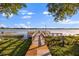 Charming wooden dock offering access to the lake, surrounded by lush greenery at 240 Killarney Bay Ct # 4, Winter Park, FL 32789