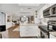 Open kitchen with modern appliances, white cabinets, flowing into a spacious living area at 240 Killarney Bay Ct # 4, Winter Park, FL 32789