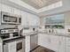 Bright kitchen with stainless steel appliances, white cabinets, and modern countertops at 240 Killarney Bay Ct # 4, Winter Park, FL 32789