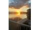 Breathtaking sunset over the lake visible from the charming wooden dock and railing at 240 Killarney Bay Ct # 4, Winter Park, FL 32789