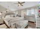 Bright main bedroom with mirrored wall, ceiling fan, and natural light at 240 Killarney Bay Ct # 4, Winter Park, FL 32789