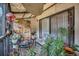 Comfortable screened patio featuring stylish furniture, plants, and decorative hanging lights at 240 Killarney Bay Ct # 4, Winter Park, FL 32789