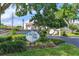 Community sign with lush greenery, enhancing curb appeal and welcoming residents and guests at 240 Killarney Bay Ct # 4, Winter Park, FL 32789
