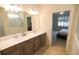 Bright bathroom with double vanity, neutral countertops and view of bedroom at 2612 Summer Clouds Way, Kissimmee, FL 34744