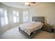 Brightly lit bedroom featuring a ceiling fan, large windows, and a cozy bed at 2612 Summer Clouds Way, Kissimmee, FL 34744