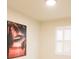 Bedroom with modern shutters, neutral walls, and vibrant tropical artwork at 2612 Summer Clouds Way, Kissimmee, FL 34744