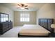 Bedroom with carpeted floor and neutral walls, featuring a ceiling fan and bright window at 2612 Summer Clouds Way, Kissimmee, FL 34744
