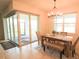 Well lit dining area with sliders to the outside and modern light fixture at 2612 Summer Clouds Way, Kissimmee, FL 34744