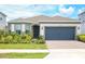 Charming single-Gathering home featuring a well-maintained lawn and a two-car garage at 2612 Summer Clouds Way, Kissimmee, FL 34744