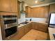 Bright kitchen featuring a large island, stainless steel appliances and ample cabinet space at 2612 Summer Clouds Way, Kissimmee, FL 34744