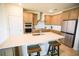 Modern kitchen featuring a large island with seating, stainless steel appliances, and ample storage at 2612 Summer Clouds Way, Kissimmee, FL 34744