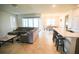 Bright open-concept living space featuring tiled floors, a comfortable sectional and access to the patio at 2612 Summer Clouds Way, Kissimmee, FL 34744