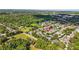 Expansive aerial view of a quiet neighborhood with lush greenery and pond at 2865 Ashton Ter, Oviedo, FL 32765