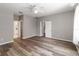 Empty bedroom with neutral paint, wood floors, ceiling fan, and multiple access doors at 2865 Ashton Ter, Oviedo, FL 32765