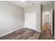 Bright bedroom featuring wood-look floors, a closet with bi-fold doors, and a ceiling fan at 2865 Ashton Ter, Oviedo, FL 32765
