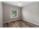 Bedroom featuring wood-look floors, a ceiling fan, a window, and neutral colored walls at 2865 Ashton Ter, Oviedo, FL 32765