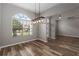 Dining room with a modern light fixture and a large window at 2865 Ashton Ter, Oviedo, FL 32765