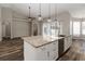 Open kitchen with island, stainless appliances, and access to the dining and outdoor spaces at 2865 Ashton Ter, Oviedo, FL 32765