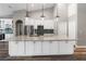 Bright kitchen showcasing a large island, granite countertops, stylish lighting, and stainless steel appliances at 2865 Ashton Ter, Oviedo, FL 32765