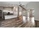 Open-concept living space featuring wood floors, high ceilings, and a modern kitchen with a large granite island at 2865 Ashton Ter, Oviedo, FL 32765