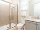 Bathroom with a glass shower, toilet, and vanity with light stone countertops at 3004 Latitude Ln, Kissimmee, FL 34747