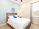 Bedroom featuring a wooden bed frame, blue accent wall, and bright window at 3004 Latitude Ln, Kissimmee, FL 34747