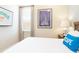 Bright bedroom with a sailboat art print, neutral curtains, and a side table at 3004 Latitude Ln, Kissimmee, FL 34747