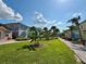 Scenic view of a community with colorful homes, palm trees, and meticulously manicured lawns at 3004 Latitude Ln, Kissimmee, FL 34747