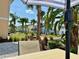 Serene community view with palm trees, colorful homes, and lush landscaping, creating a tropical paradise at 3004 Latitude Ln, Kissimmee, FL 34747