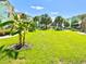 Lush community lawn features vibrant green grass, palm trees, and tropical landscaping surrounding colorful Margaritaville homes at 3004 Latitude Ln, Kissimmee, FL 34747