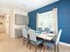 Elegant dining area with seating for six, accent wall, and lots of light at 3004 Latitude Ln, Kissimmee, FL 34747