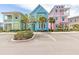 Charming, colorful Margaritaville homes boast a vibrant aesthetic, complemented by lush tropical landscaping at 3004 Latitude Ln, Kissimmee, FL 34747