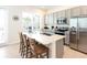 Modern kitchen with stainless steel appliances, a central island, and breakfast bar seating at 3004 Latitude Ln, Kissimmee, FL 34747