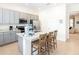 Contemporary kitchen featuring a large island with bar stools and modern appliances at 3004 Latitude Ln, Kissimmee, FL 34747
