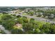 Aerial view showcasing the proximity of the property to the adjacent highway and the mature trees on the property at 321 Beard Rd, Winter Garden, FL 34787