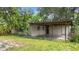 A home's covered carport is attached with a small amount of unkempt landscaping at 321 Beard Rd, Winter Garden, FL 34787