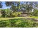 A home with front yard is surrounded by lush mature trees and greenery at 321 Beard Rd, Winter Garden, FL 34787