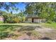 A quaint single story home with mature trees is surrounded by lush greenery at 321 Beard Rd, Winter Garden, FL 34787