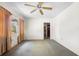 A living room featuring a ceiling fan and a window needing renovation at 321 Beard Rd, Winter Garden, FL 34787