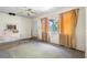 A living room featuring a ceiling fan, window, and wall-mounted air conditioner needing work at 321 Beard Rd, Winter Garden, FL 34787