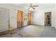 A living room with ceiling fan, a window, and an exterior door needing renovation at 321 Beard Rd, Winter Garden, FL 34787