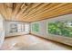 Living room features large windows and a wooden ceiling adding warmth, ready for new flooring and decor at 321 Beard Rd, Winter Garden, FL 34787