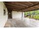 Covered patio ideal for outdoor dining and relaxation, with views of greenery and the backyard at 321 Beard Rd, Winter Garden, FL 34787